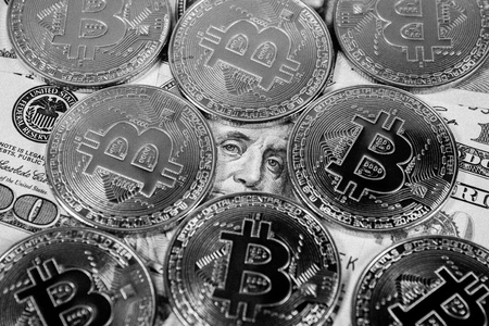 New virtual money Golden bitcoin coin on us dollars background . Cryptocurrency. Business and Trading concept. Close-up shot. black and white imageの写真素材