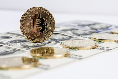 New virtual money Golden bitcoin coin on us dollars background . Cryptocurrency. Business and Trading concept.の写真素材