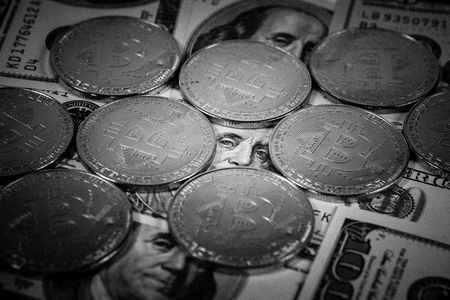 New virtual money Golden bitcoin coin on us dollars background . Cryptocurrency. Business and Trading concept. Close-up shot. black and white imageの写真素材