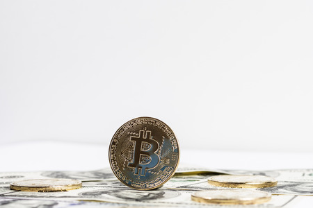New virtual money Golden bitcoin coin on us dollars background . Cryptocurrency. Business and Trading concept.の写真素材