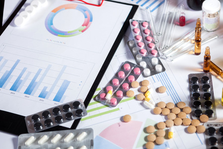 Medical marketing and Health care business analysis report. Pile of pills in blister packs backgroundの写真素材