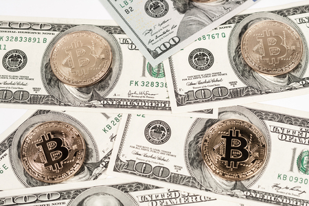 New virtual money Golden bitcoin coin on us dollars background . Cryptocurrency. Business and Trading concept.の写真素材