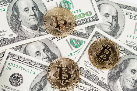 New virtual money Golden bitcoin coin on us dollars background . Cryptocurrency. Business and Trading concept.の写真素材