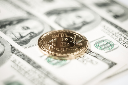 New virtual money Golden bitcoin coin on us dollars background . Cryptocurrency. Business and Trading concept.の写真素材