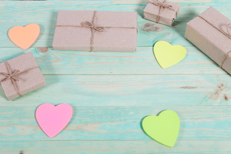 Gift boxes wrapped kraft paper tied with twine and sticker heart and tied with twine. with copy spaceの写真素材