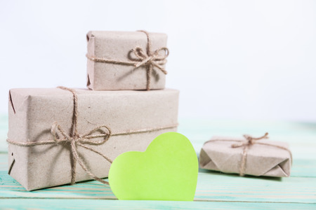 Gift boxes wrapped kraft paper tied with twine and sticker heart and tied with twine. with copy spaceの写真素材
