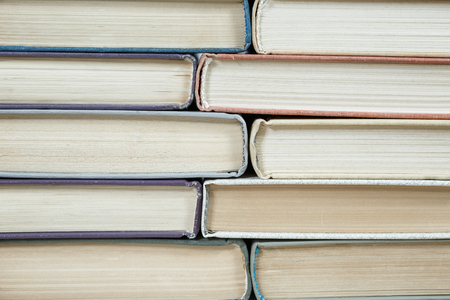 Chaotic stack of old books pastel colors, selective focus with copy spaceの写真素材