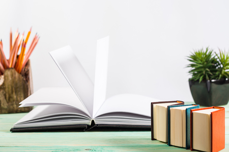 Pile of miniature books on wooden background. With copy space for your textの写真素材