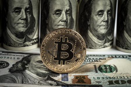 New virtual money Golden bitcoin coin on us dollars background . Cryptocurrency. Business and Trading concept. Close-up shotの写真素材
