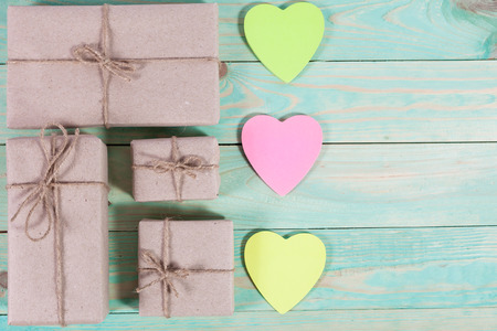 Gift boxes wrapped kraft paper tied with twine and sticker heart and tied with twine. with copy spaceの写真素材