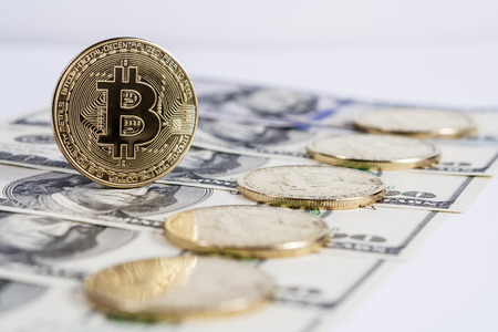 New virtual money Golden bitcoin coin on us dollars background . Cryptocurrency. Business and Trading concept.の写真素材