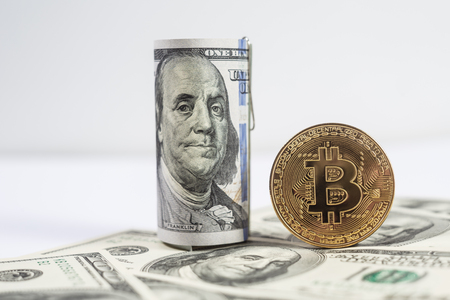 New virtual money Golden bitcoin coin on us dollars background . Cryptocurrency. Business and Trading concept.の写真素材