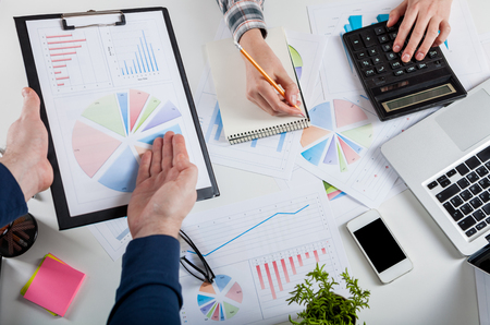 Business people discussing the charts and graphs showing the results of their successful teamwork. Forex Trade Graph Chart Concept. Stock market chart and finger pointing on tablet in office.の写真素材