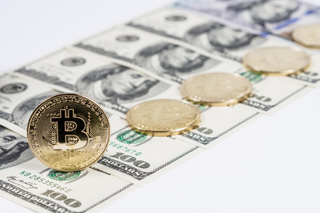 New virtual money Golden bitcoin coin on us dollars background . Cryptocurrency. Business and Trading concept.の写真素材