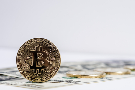 New virtual money Golden bitcoin coin on us dollars background . Cryptocurrency. Business and Trading concept. Close-up shotの写真素材