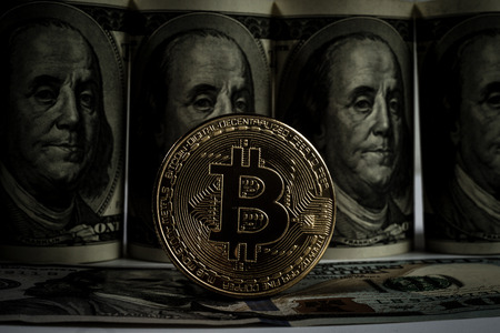 New virtual money Golden bitcoin coin on us dollars background . Cryptocurrency. Business and Trading concept. Close-up shotの写真素材