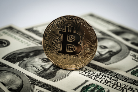 New virtual money Golden bitcoin coin on us dollars background . Cryptocurrency. Business and Trading concept. Close-up shotの写真素材