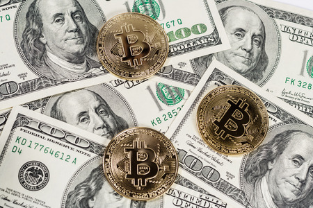 New virtual money Golden bitcoin coin on us dollars background . Cryptocurrency. Business and Trading concept.の写真素材
