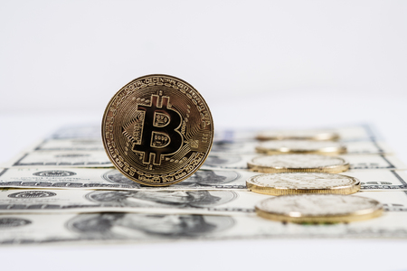 New virtual money Golden bitcoin coin on us dollars background . Cryptocurrency. Business and Trading concept.の写真素材