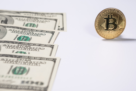 New virtual money Golden bitcoin coin on us dollars background . Cryptocurrency. Business and Trading concept.の写真素材