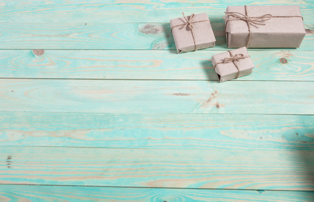 Presents for any holiday concept. Border of decorative gifts wrapped kraft paper tied with tourniquet for christmas, valentine day or birthdayの写真素材