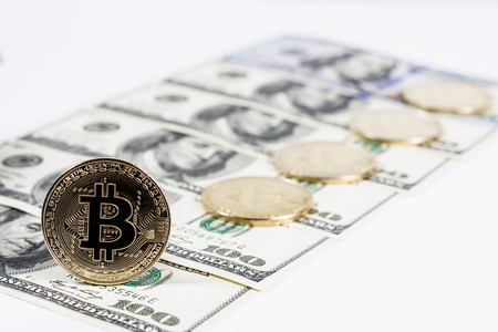 New virtual money Golden bitcoin coin on us dollars background . Cryptocurrency. Business and Trading concept.の写真素材