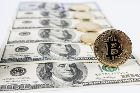 New virtual money Golden bitcoin coin on us dollars background . Cryptocurrency. Business and Trading concept.の写真素材