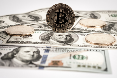 New virtual money Golden bitcoin coin on us dollars background . Cryptocurrency. Business and Trading concept.の写真素材
