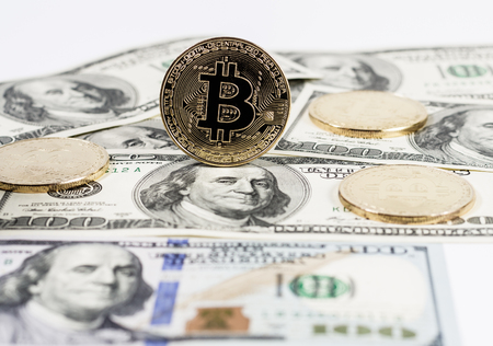 New virtual money Golden bitcoin coin on us dollars background . Cryptocurrency. Business and Trading concept.の写真素材