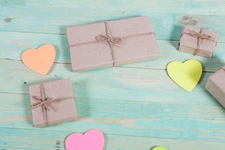 Gift boxes wrapped kraft paper tied with twine and sticker heart and tied with twine. with copy spaceの写真素材