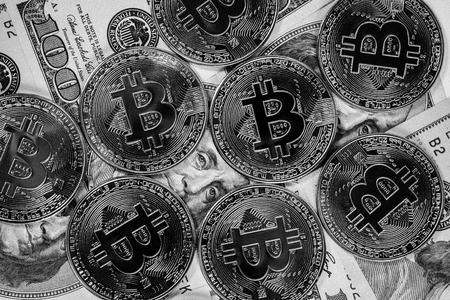 New virtual money Golden bitcoin coin on us dollars background . Cryptocurrency. Business and Trading concept. Close-up shot. black and white imageの写真素材