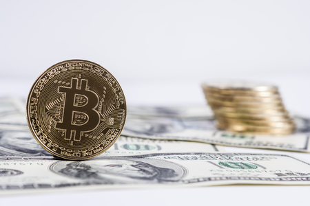 New virtual money Golden bitcoin coin on us dollars background . Cryptocurrency. Business and Trading concept.の写真素材