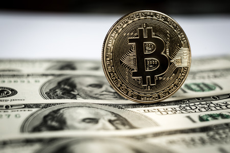 New virtual money Golden bitcoin coin on us dollars background . Cryptocurrency. Business and Trading concept. Close-up shotの写真素材