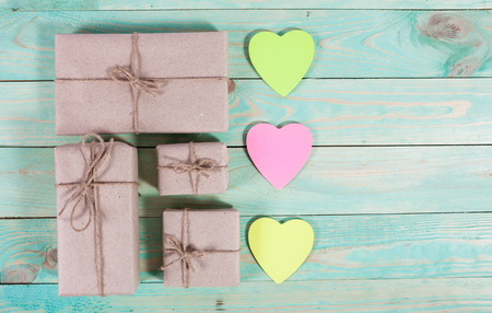 Gift boxes wrapped kraft paper tied with twine and sticker heart and tied with twine. with copy spaceの写真素材