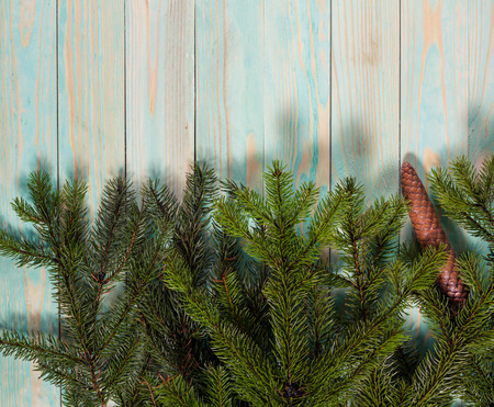 Christmas background  with spruce branches on wooden board with copy spaceの写真素材