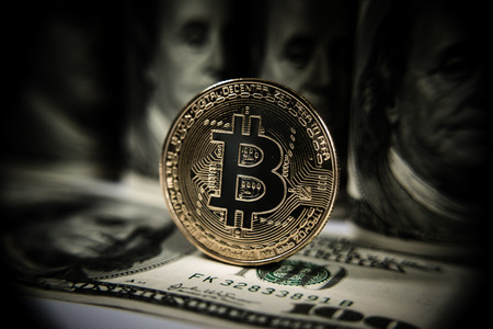 New virtual money Golden bitcoin coin on us dollars background . Cryptocurrency. Business and Trading concept. Close-up shotの写真素材