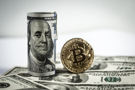 New virtual money Golden bitcoin coin on us dollars background . Cryptocurrency. Business and Trading concept.の写真素材
