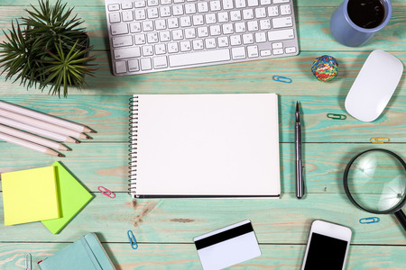 Office desk table with laptop, pen and notebook. Top view with copy space. Online shopping concept.の写真素材