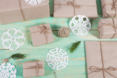 Gift boxes wrapped kraft paper tied with twine and paper snowflake and tied with twine. with copy spaceの写真素材