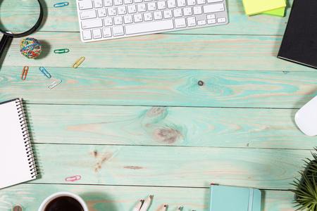Blue office desk table with with office supplies. Top view with copy spaceの写真素材