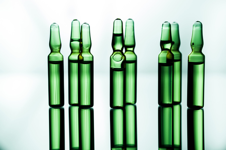 Group object of liquid medicinal agent in limpid glassware in medical laboratory. Group of ampoules with a transparent medicine in medical laboratoryの写真素材