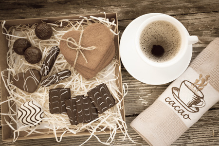 White cup of coffee on a natural old wooden background with biscuits. Selective focus. With copy spaceの写真素材