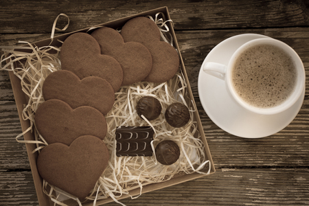 White cup of coffee on a natural old wooden background with biscuits. Selective focus. With copy spaceの写真素材