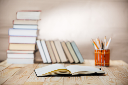 Open textbooks on wood desk with blurred focus for education background. Back to school conceptの写真素材