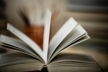 Open textbooks on wood desk with blurred focus for education background. Back to school conceptの写真素材
