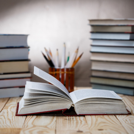Open textbooks on wood desk with blurred focus for education background. Back to school conceptの写真素材