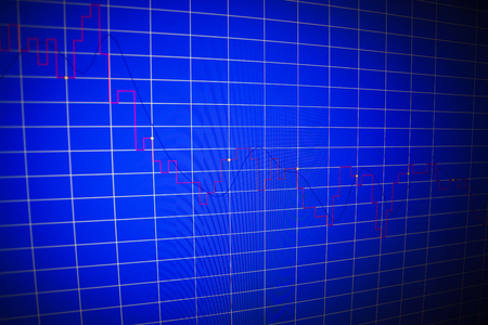 Financial graph on a computer monitor screen. Background stock chart. Analysing stock market data on a monitor. Blue background with stock chart. Finance concept. Tools of technical analysis.の写真素材
