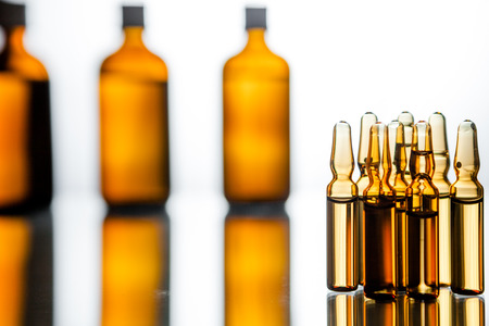 Group object of liquid medicinal agent in limpid glassware in medical laboratory. Group of ampoules with a transparent medicine in medical laboratoryの写真素材