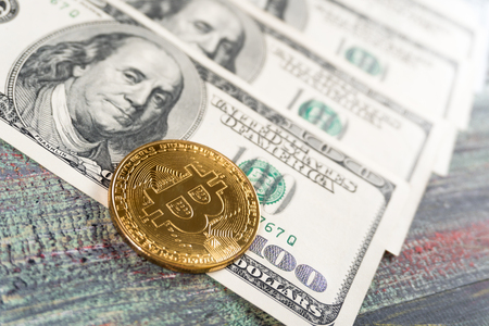 Bitcoin and money on a colored wooden background. Bitcoin golden coin New virtual moneyの写真素材