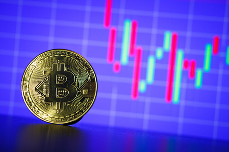 Bitcoin gold coin on the background of the graph of the monitor. Business conceptの写真素材